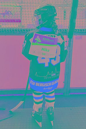 Kind mit Eishockey-Ausrüstung und MUKOmove-Startnummer - von hinten zu sehen, in einer Eishalle