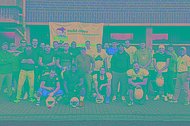 Gruppenfoto von Footballern vor einem MUKOmove-Banner im Freien