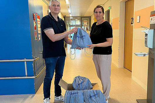 CF-Patientenvertreterin Susanne Jungermann überreicht PD Dr. Olaf Sommerburg vom Mukoviszidose-Zentrum am Uniklinikum Heidelberg die Hope Bags. 