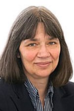 Bild Ute Düvelius Portrait einer Frau mit braunen schulterlangen Haaren, einer gestreiften Bluse und einem Blazer